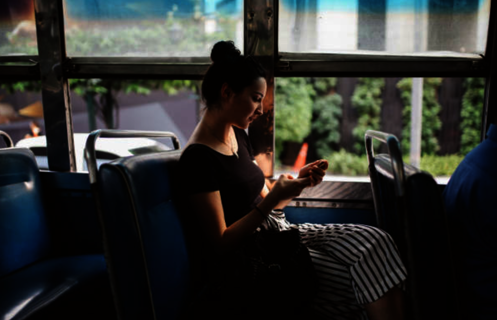 Young woman riding city bus