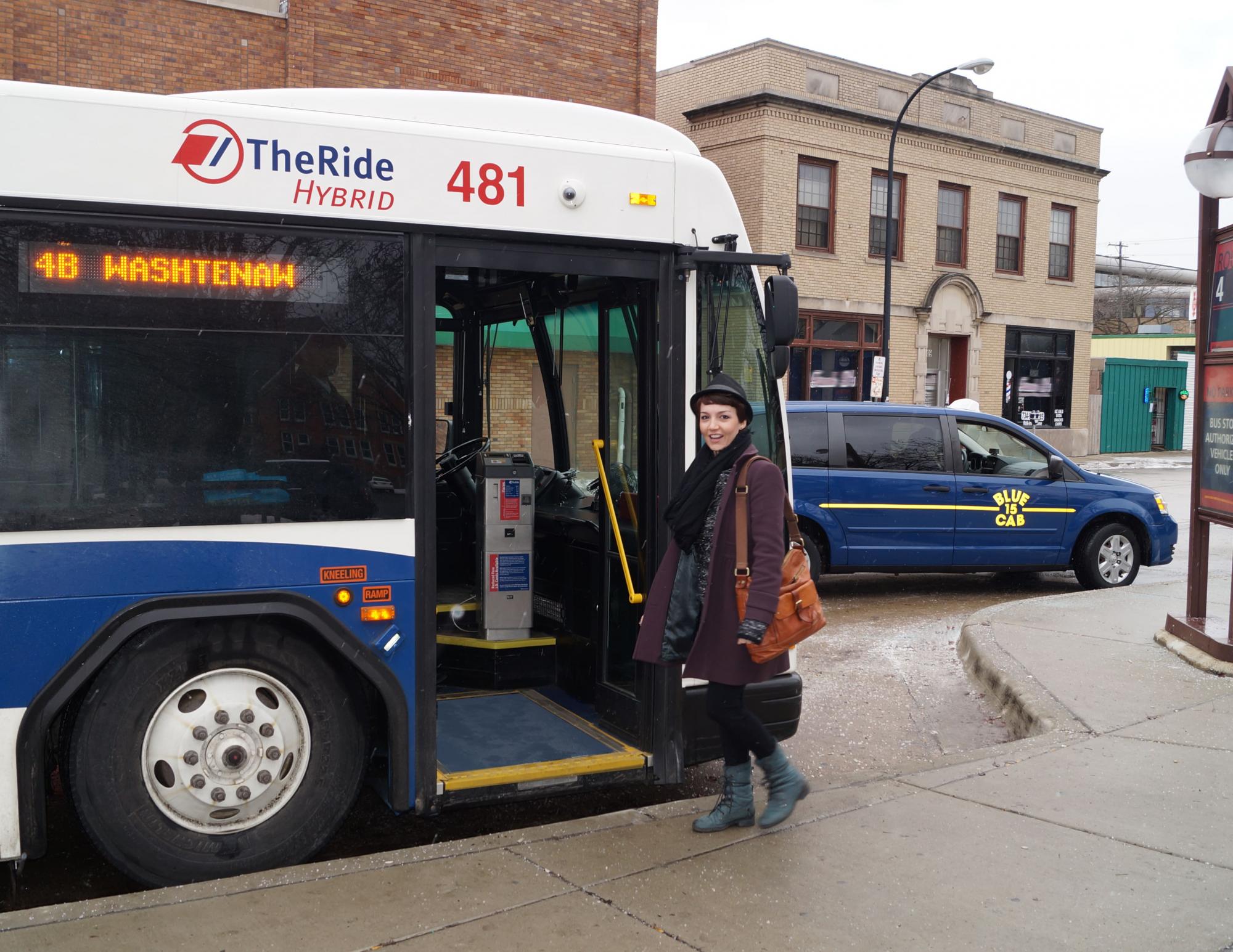 A woman boarding the bus in downtown Ann Arbor.