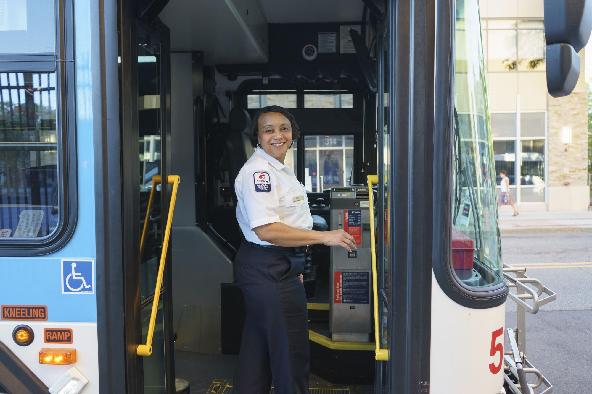 A bus driver gets ready to board her bus for her shift.