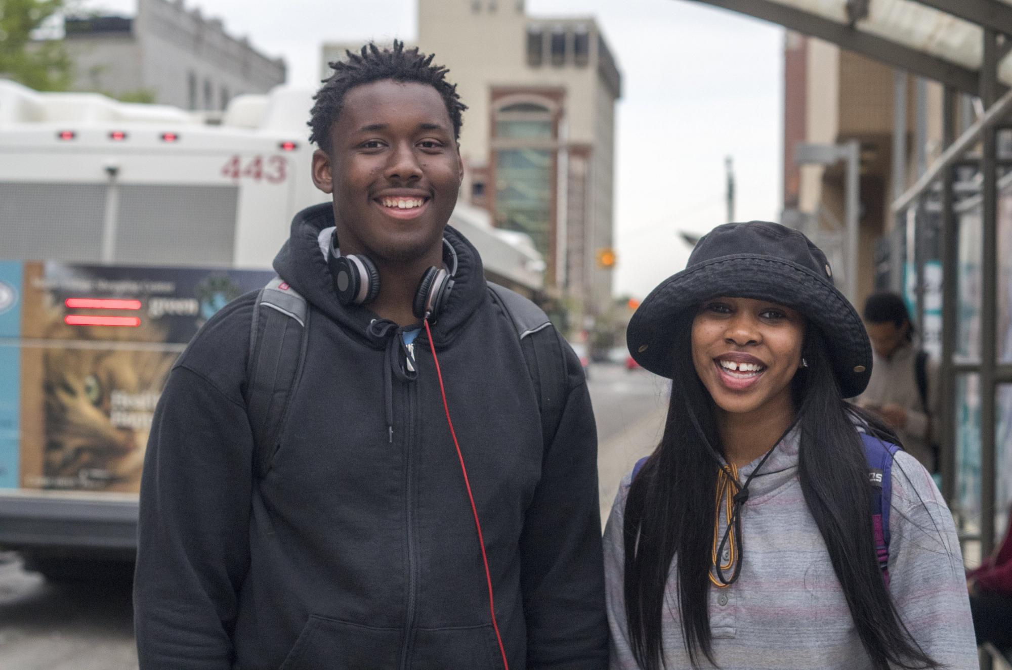 A couple high school students get ready to ride the bus. 