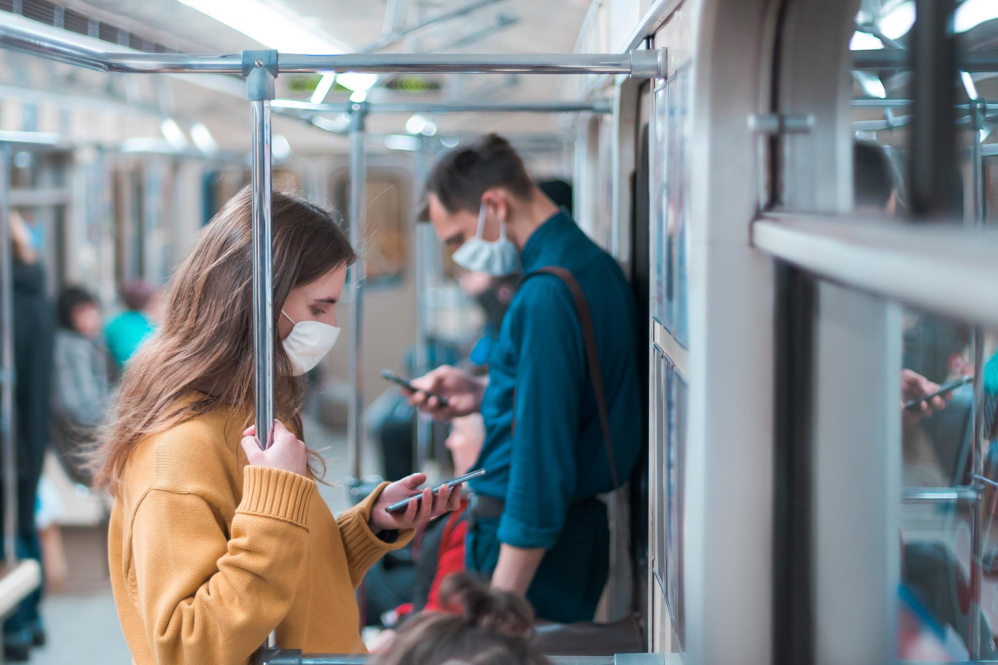 Commuters wearing masks on public transportation