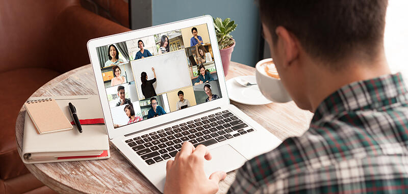 Man in virtual meeting on laptop