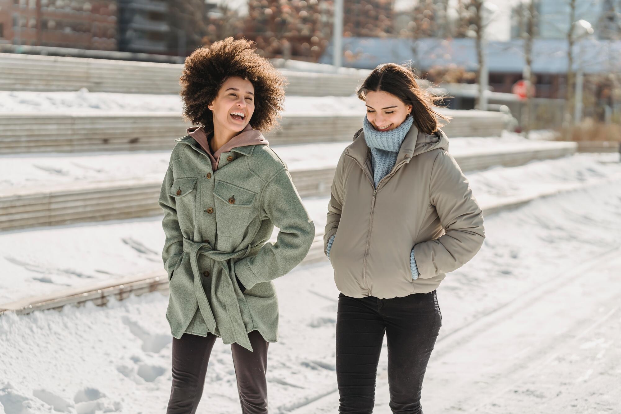 Two women walking in winter weather.