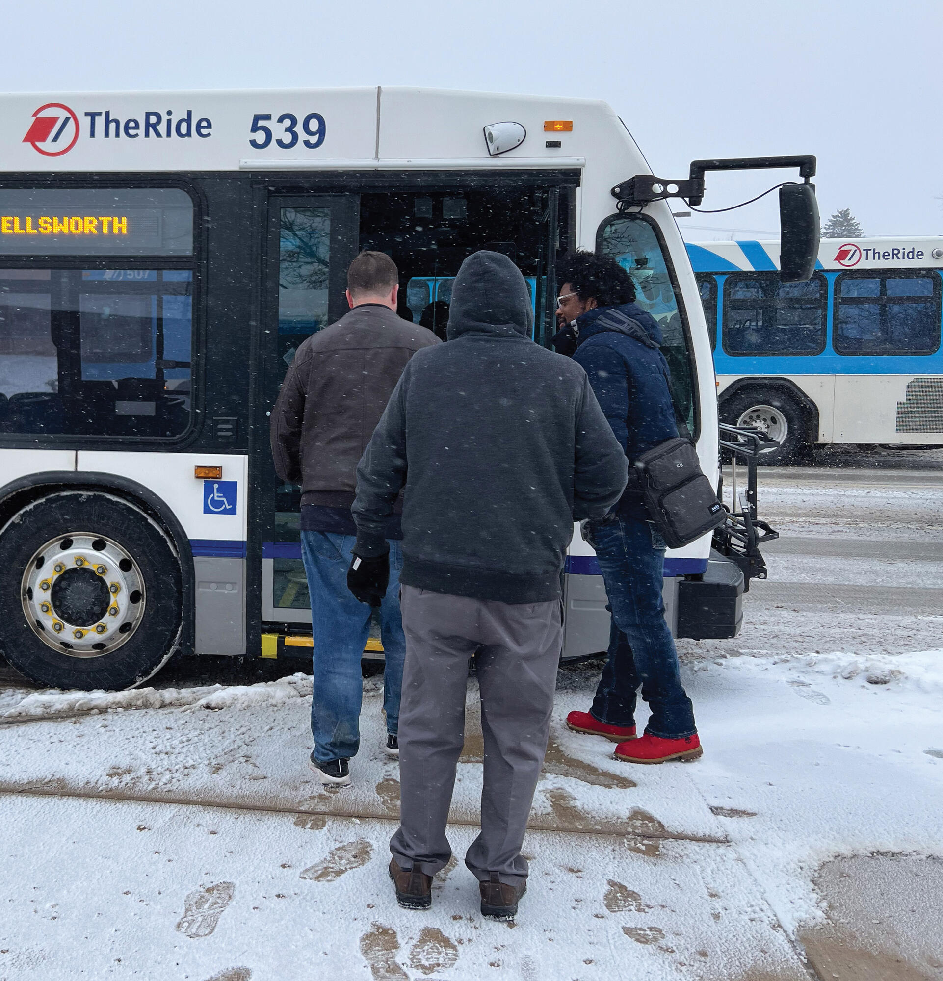Photo of riders boarding bus in winter