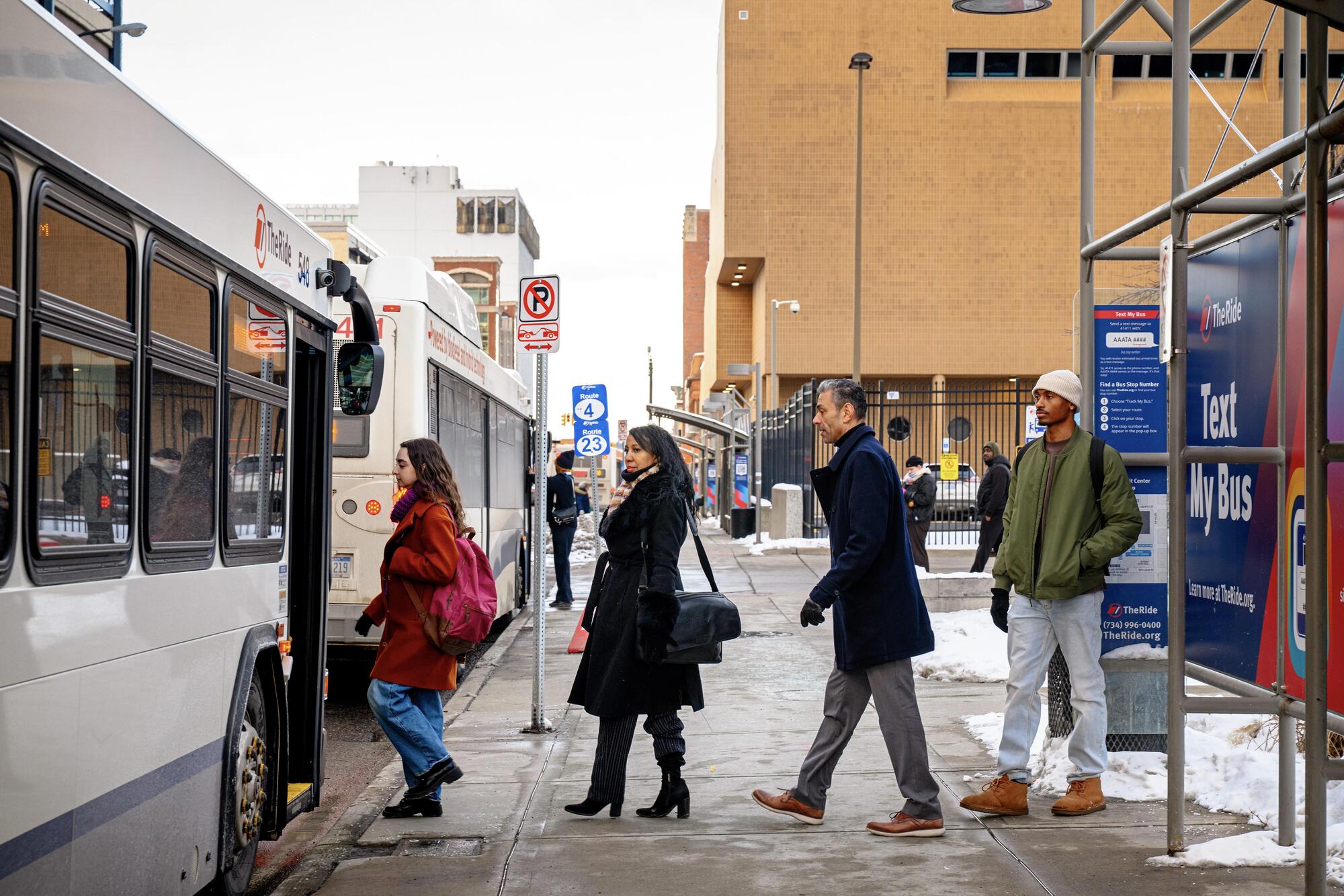 Riders boarding a TheRide bus at the BTC