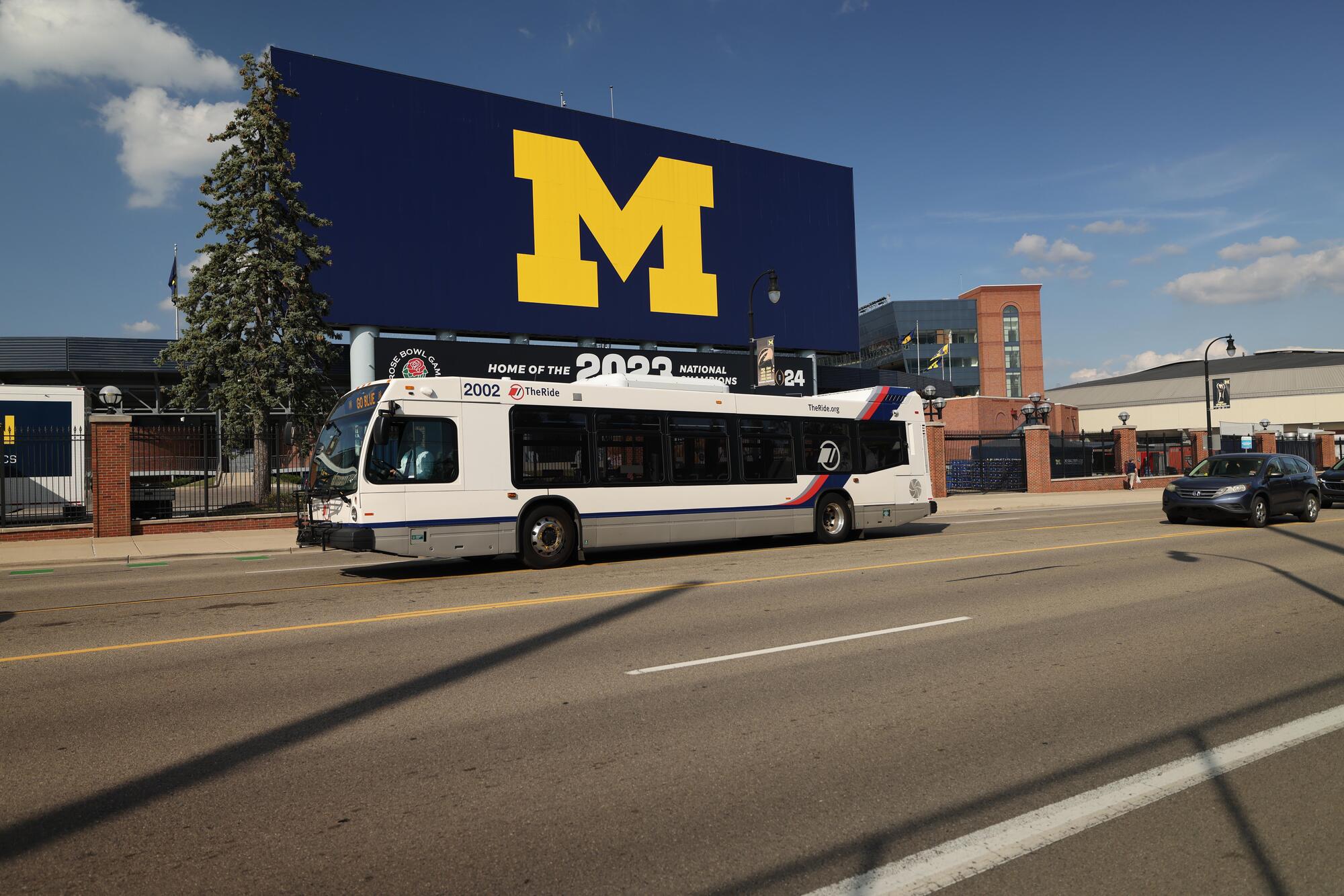 Image of a TheRide bus driving past Michigan Stadium