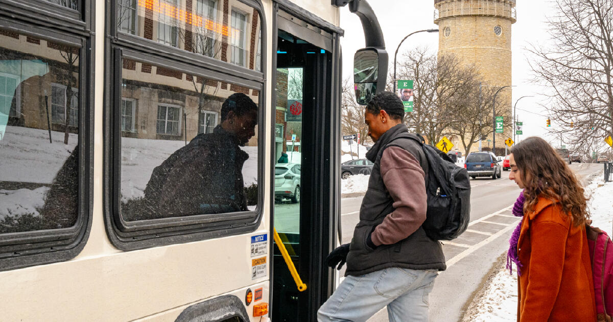 Photo of 2 riders boarding a bus in Ypsilanti in winter