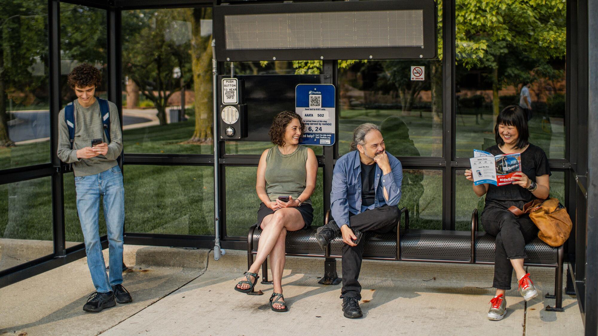 Passengers waiting in a bus shelter