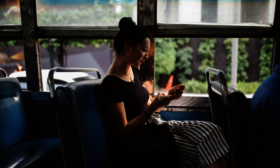 Young woman riding city bus