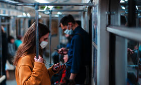 Commuters wearing masks on public transportation