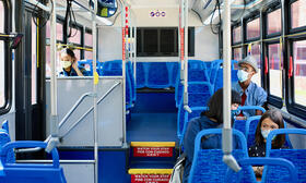 bus riders in masks riding the bus