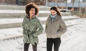 Two women walking in winter weather.