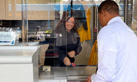 Information Specialist selling pass to customer at Ypsilanti Transit Center