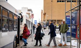 Riders boarding a TheRide bus at the BTC