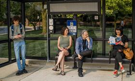 Passengers waiting in a bus shelter