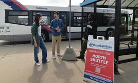 Photo of riders at TheRide's FootballRide North Shuttle Stop on Plymouth Rd.